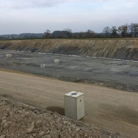 Large earthworks site with an embankment slope and compacted surface