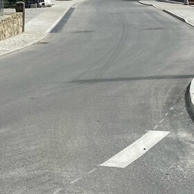 Newly paved street with curb and sidewalk