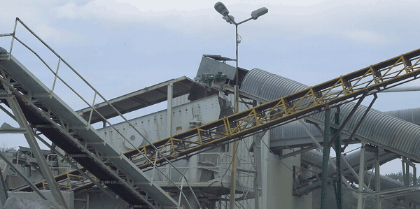 Conveyor system transporting crushed rock in a processing plant